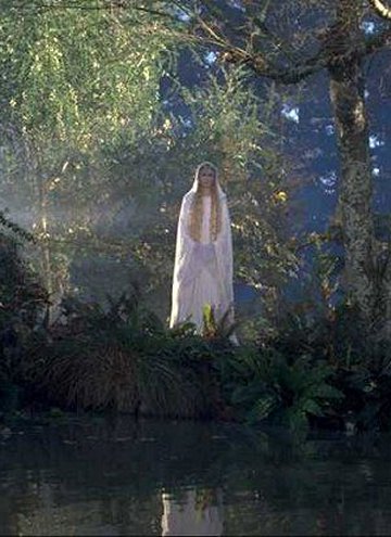 A picture of Galadriel standing on a riverbank.
