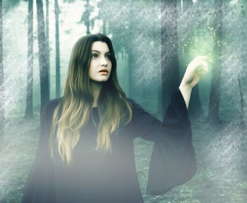A picture of a woman casting a spell in a forest.